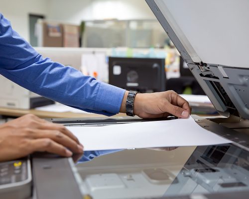 Business people put a4 paper on the copier to scaning.